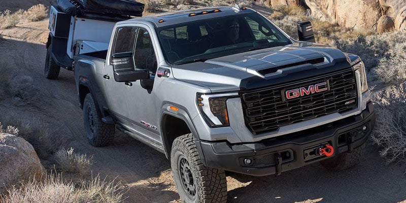 2026 GMC Sierra 2500 HD towing heavy equipment to showcase its powerful performance in Clinton, NC