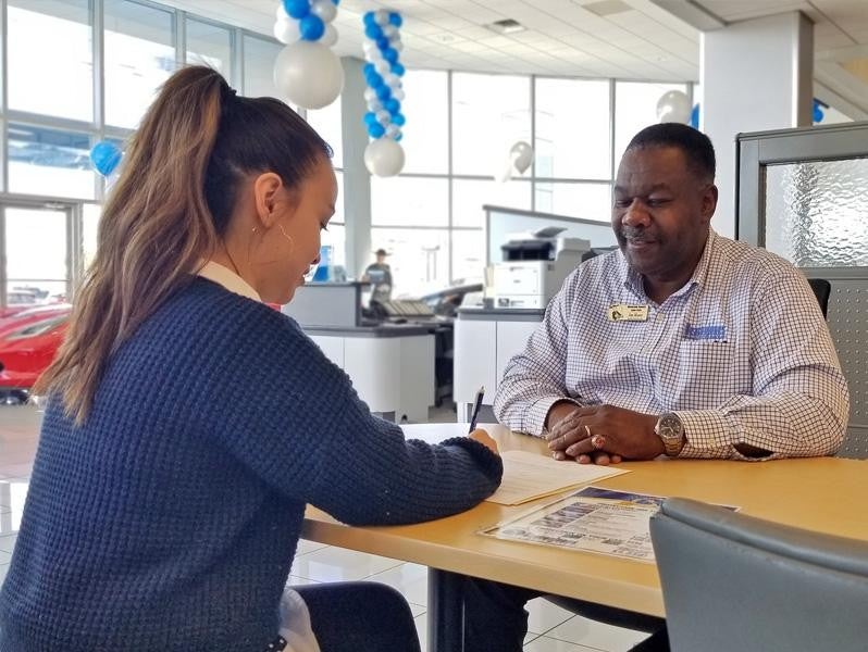 woman signing papers